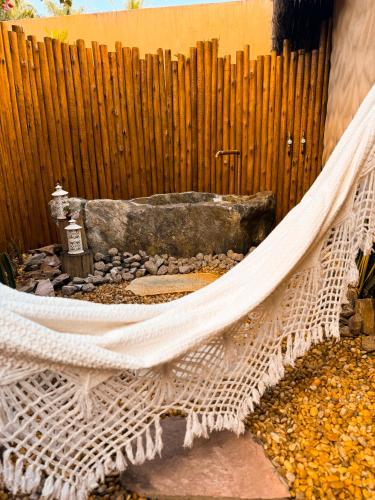 a hammock in a backyard with a wooden fence at Vila Cerrado in Alto Paraíso de Goiás