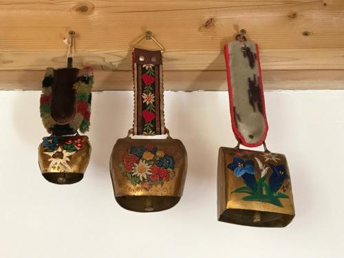 a group of four vases hanging on a wall at Chalet avec bain nordique et sauna in Dabo