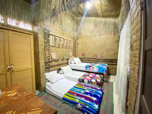 a bedroom with two beds in a room at Pelemkecut Double-Degree Syariah Accommodation in Kejayan
