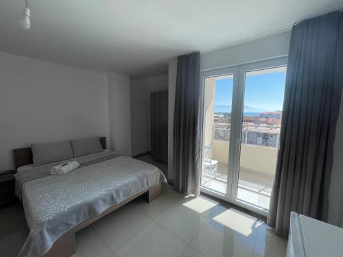 a bedroom with a bed and a large window at Hotel Majestic in Struga