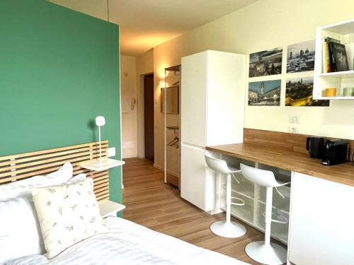 a bedroom with a bed and a desk in it at Una finestra sul parco in Bergamo