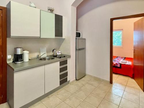 a kitchen with a sink and a refrigerator at Boris Apartments in Petrovac na Moru