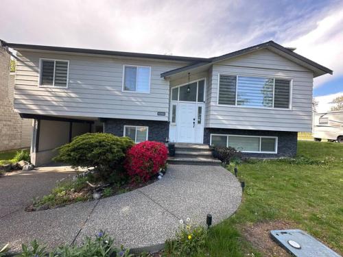 a house with a white door and a driveway at Sabrina's Home in Delta