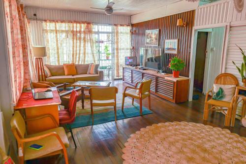 a living room with a couch and a table and chairs at SMITH'S HOMESTAY in Georgetown