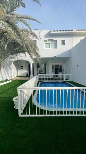 a swimming pool in the yard of a house at درة العروس فيلا الذهبي 38 in Durat  Alarous