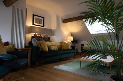 a living room with a couch and a potted plant at Chester Townhouse inside Roman Walls in Chester