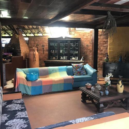 a living room with a couch and a table at Pousada Bora Bora in Guarapari