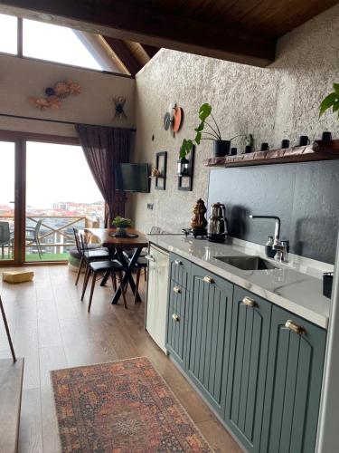 a kitchen with a sink and a table at Lavinya Suit Bungalov in Rize