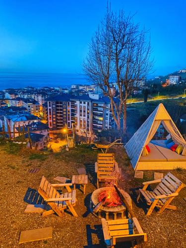 a group of chairs and a tent and a fire at Lavinya Suit Bungalov in Rize