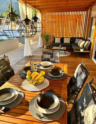 a wooden table with plates of fruit on top of it at Ayana Mobile Home in Orebić