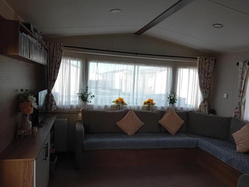 a living room with a couch in front of a window at Caravan in Jaywick,Jaywick sand, Clacton-on-sea in Jaywick Sands