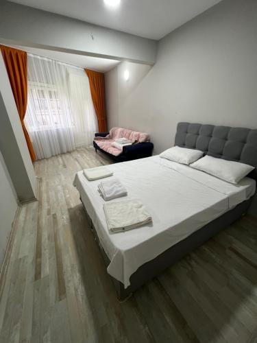 a bedroom with a large bed and a couch at Red sophia suites in Istanbul
