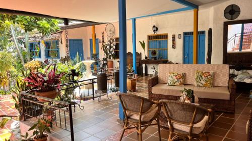 a patio with a couch and chairs and plants at Hotel Casa Oliveros in Rivera