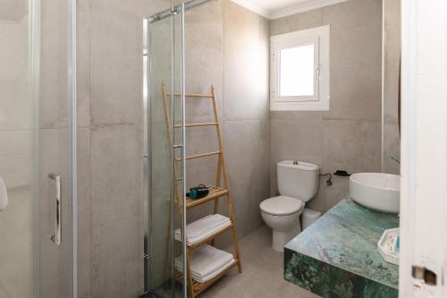 a bathroom with a shower and a toilet and a sink at H Bellavista Mojácar in Mojácar