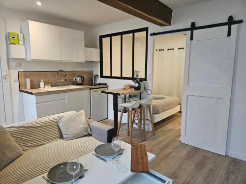a kitchen and a living room with a couch and a table at Appartement centre historique d'Auch in Auch