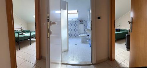 a room with a bathroom with a toilet and a bedroom at Blue Loft Hotel in Cesenatico