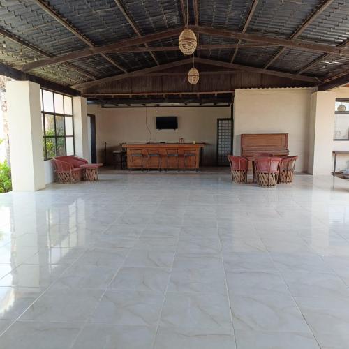 a large room with a table and chairs and a television at Quinta La Toscana in Ensenada