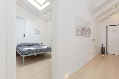 a bedroom with a bed in a white room at La casa di Po' in Trieste