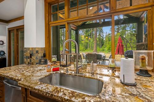 a kitchen with a sink and a large window at The 17th hole in Cle Elum