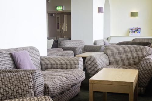 a row of couches in a waiting room at Carousel Hotel in Blackpool