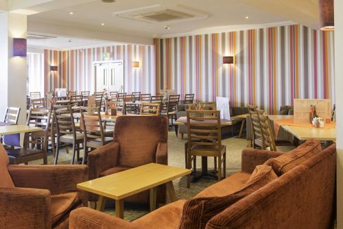 a dining room with tables and chairs and tablesktop at Carousel Hotel in Blackpool