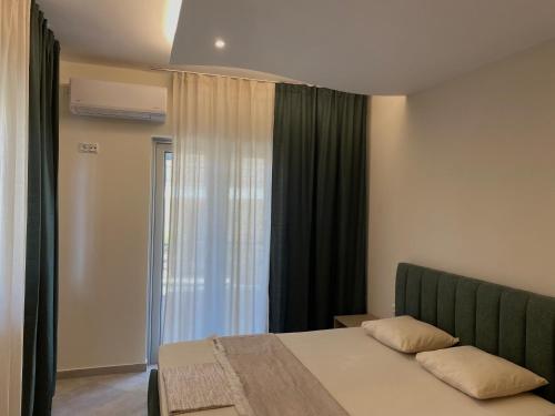 a bedroom with a bed and a window at Acqua Blu Blu apartment in Koroni