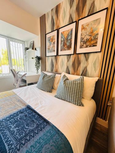 a bedroom with a bed with pillows on it at Newly Renovated Private self contained room with Private dedicated Bathroom - Selly Oak Birmingham R2 in Birmingham