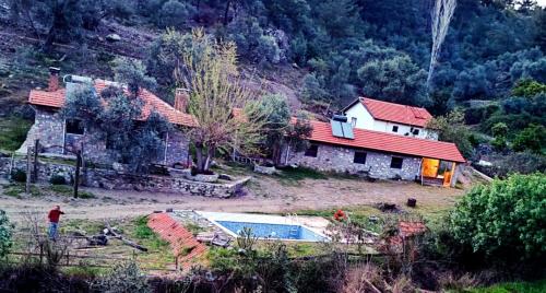 une maison avec une piscine en face d'une maison dans l'établissement Togo iztuzu Stonehouse-4, à Boğazağzı
