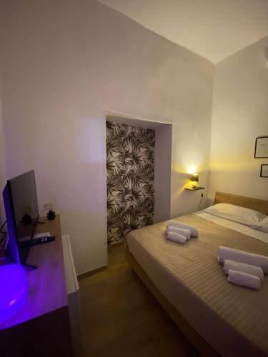 a bedroom with a bed with two towels on it at Monteleone rooms in Palermo