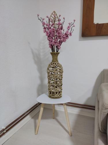 a vase with flowers in it sitting on a table at Ticina apartment in Sarajevo
