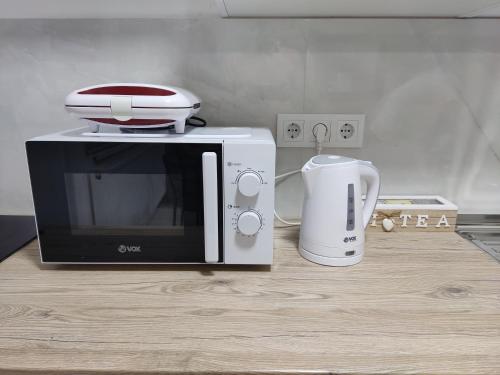 a microwave and a toaster sitting on a counter at Ticina apartment in Sarajevo