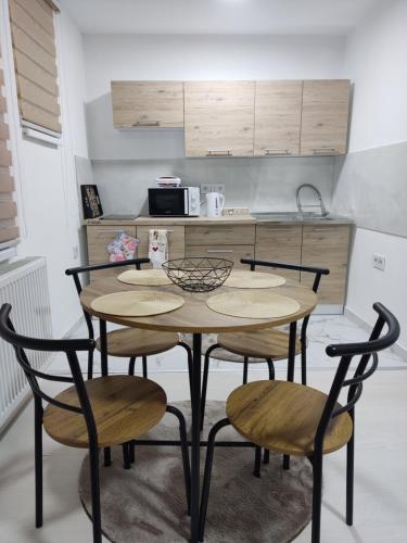 a kitchen with a table and chairs in a kitchen at Ticina apartment in Sarajevo