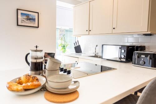 a kitchen with a counter with a plate of food on it at Northern Hideaways, Lockup Mews in Bellingham
