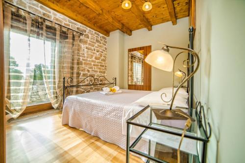 a bedroom with a bed and a glass table at Villa Major near Vrsar and Lim Fjord in Marasi