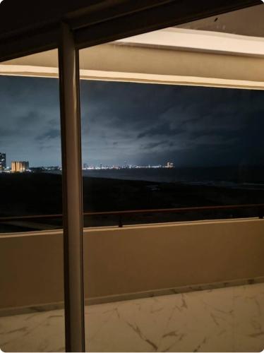 a view of the ocean from a window at Sol y mar in Boca del Río