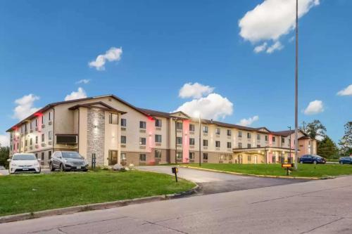 a large building with cars parked in a parking lot at Sonesta Essential Des Moines in Des Moines