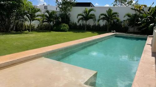 a swimming pool in the backyard of a house at Casa Dzitya in Mérida