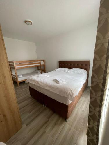 a bedroom with a bed and a wooden floor at Darija in Dobra Voda