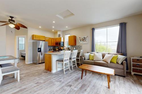 a living room and kitchen with a couch and a table at Lazy Lookout on Devils Lake in Lincoln City