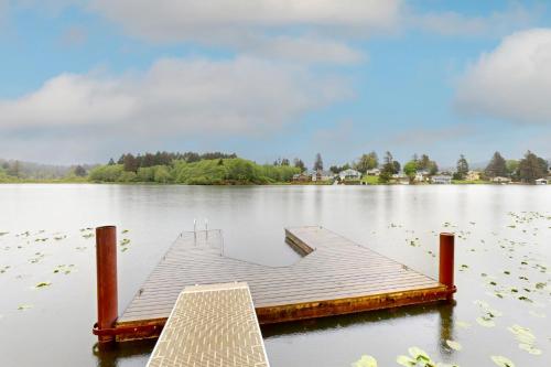 a dock in the middle of a lake at Lazy Lookout on Devils Lake in Lincoln City