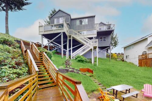 a house on a hill with stairs leading up to it at Lazy Lookout on Devils Lake in Lincoln City
