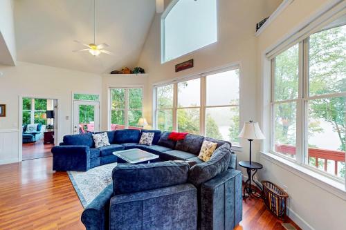 a living room with a blue couch and windows at Still Waters in Moneta
