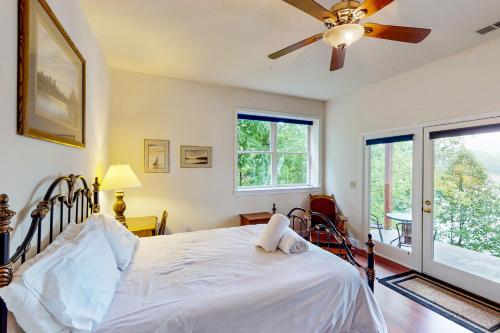 a bedroom with a bed and a ceiling fan at Still Waters in Moneta