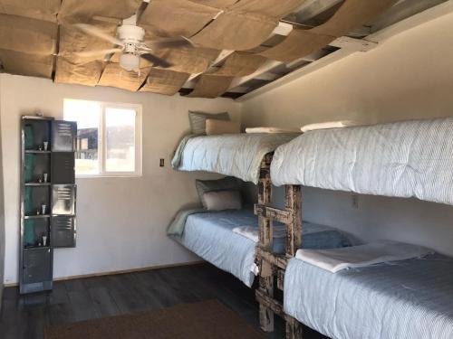 two bunk beds in a room with a ceiling at Checkpoint in Rosarito