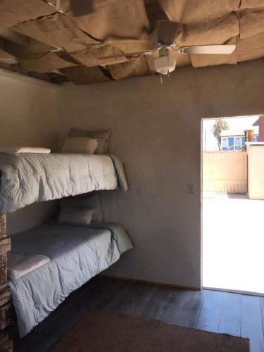 two bunk beds in a room with a window at Checkpoint in Rosarito