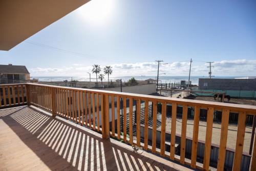 a wooden balcony with a view of the ocean at Checkpoint in Rosarito