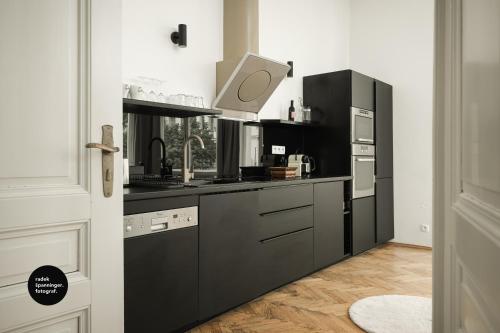 una cocina con electrodomésticos en blanco y negro en Central Apartments Pařížská en Praga