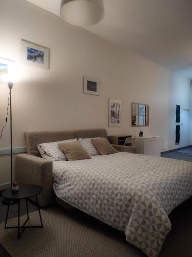 a bedroom with a bed and a couch at LFSUITE LuganoLake Terrazza Spiaggia privata Parking WI-FI Netflix in Porlezza