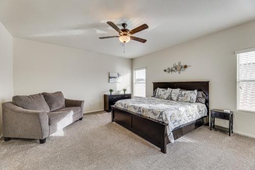 a bedroom with a bed and a chair and a ceiling fan at Gilbert Group Getaway 3 Mi to Dtwn in Gilbert
