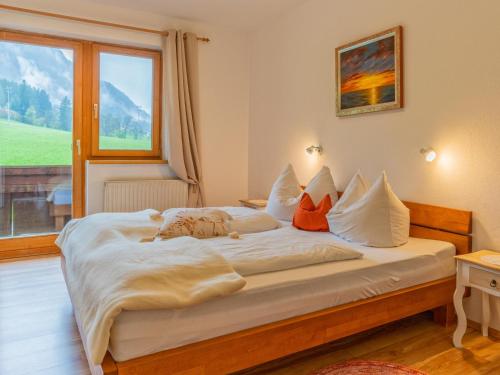 a bedroom with a large white bed with a window at Johanna in Reith im Alpbachtal